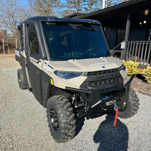 Tan Polaris Ranger XP UTV with tinted enclosure panels